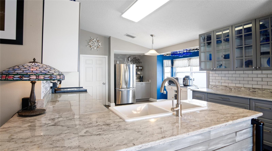 Granite counter tops make for a sleek look in the kitchen with the stainless steel appliances.