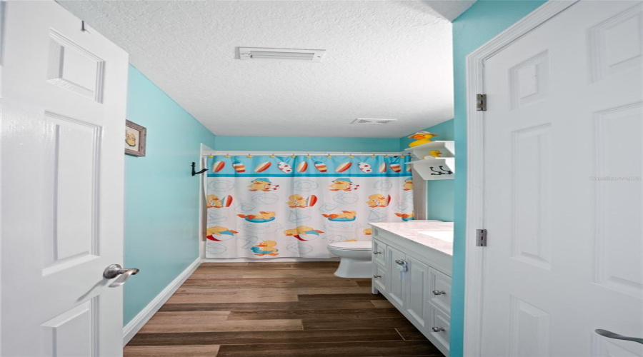 The guest bathroom is located in the hallway.