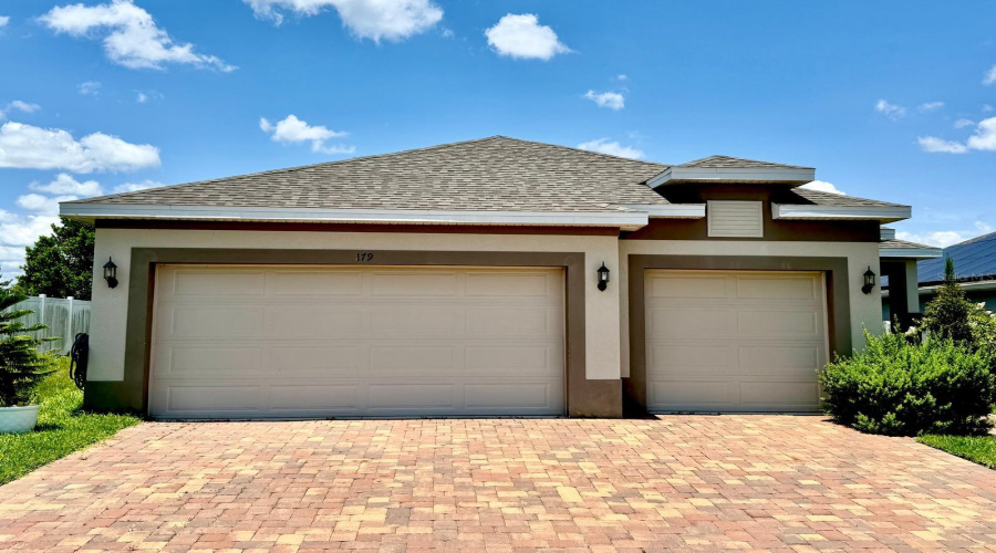 Front / 3 car garage / pavers driveway