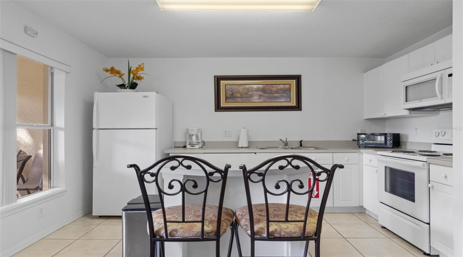 Kitchen opens to living/dining areas