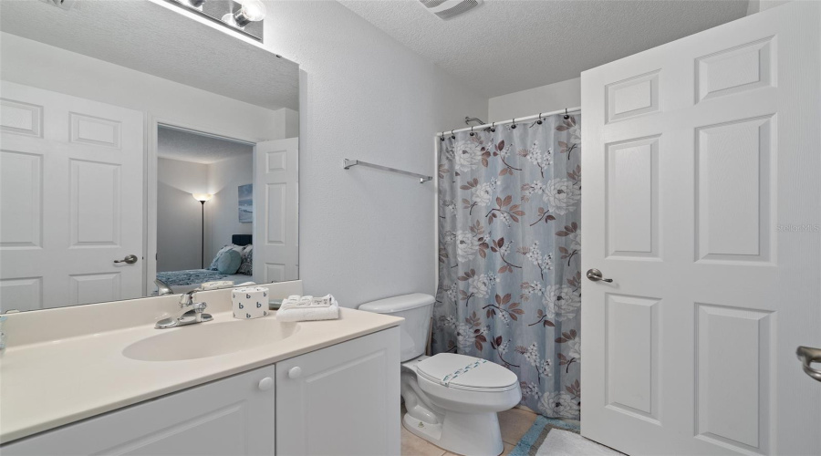 Downstairs bathroom for guests and connects to bedroom