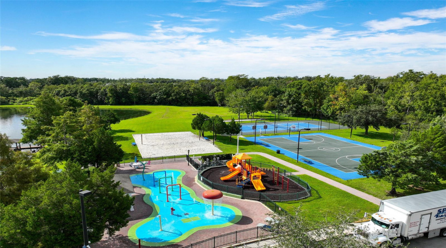 Aerial view of splash pad, playground, basketball/tennis courts and sand volleyball