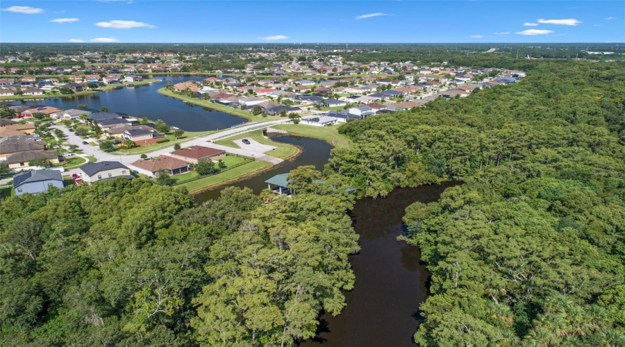 From home, boats cruise down lake and under bridge to boat lift