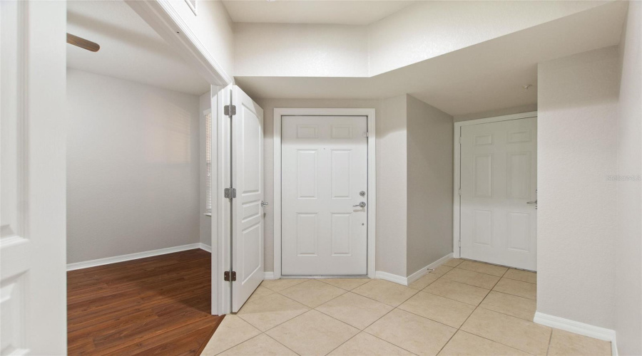 Front door entry and 3rd bedroom on left