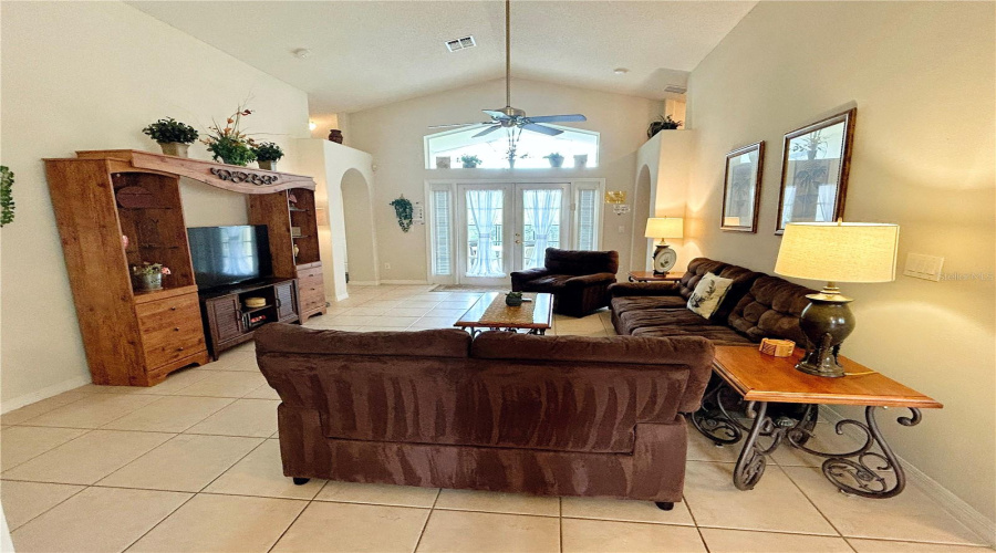 Great Room Features Vaulted Ceiling and Dual French Doors to the Lanai & Pool Area