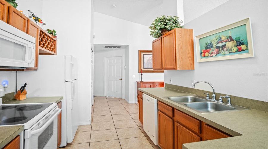 A view from the dining area through the kitchen and to the fourth bedroom.