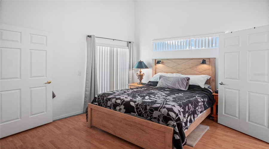 The primary bedroom has an en-suite bathroom, walk-in closet, laminate flooring, and a vaulted ceiling.