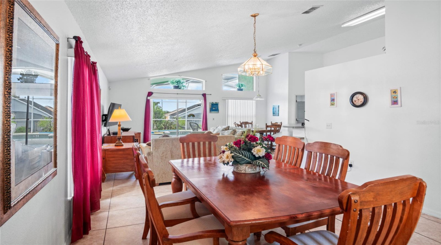 The dining room looking towards the family room and out to the lanai and pool.