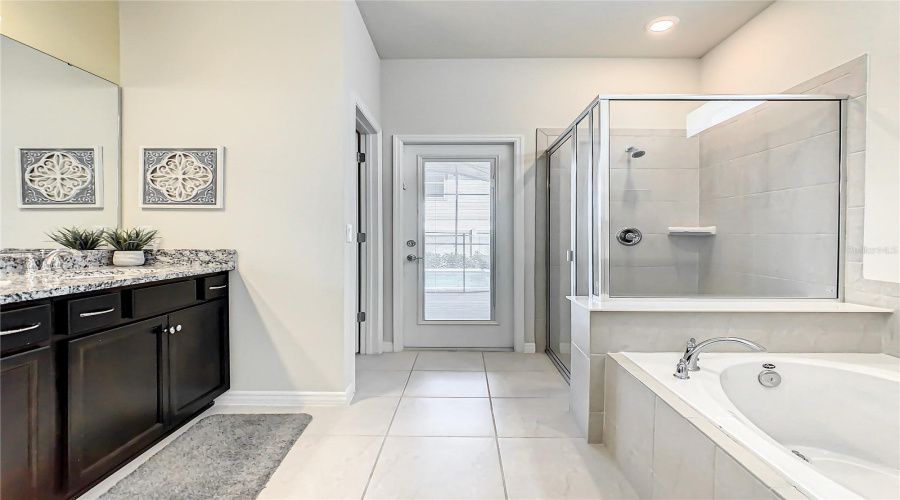 Owner Bath--Elegant owner’s bath featuring dual vanities and direct access to the pool