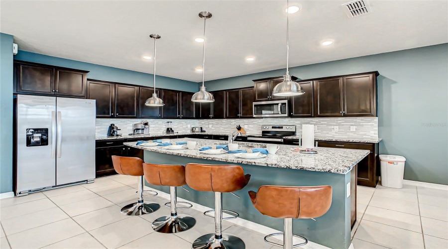 Kitchen--Large granite island perfect for dining and entertaining