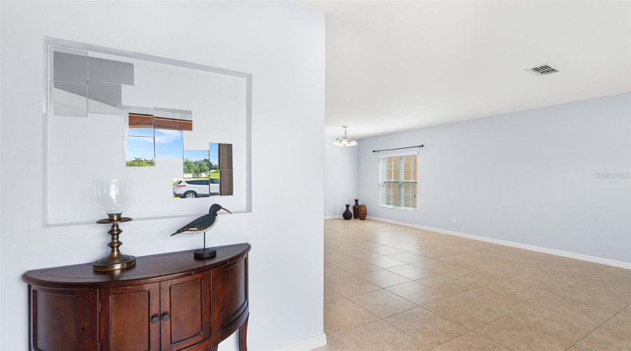 FRONT ENTRY WITH VIEW TOWARDS LIVING ROOM & DINING