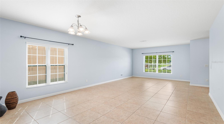 VIEW OF LIVING ROOM & DINING ROOM. FRONT ENTRY WOULD BE ON FAR RIGHT