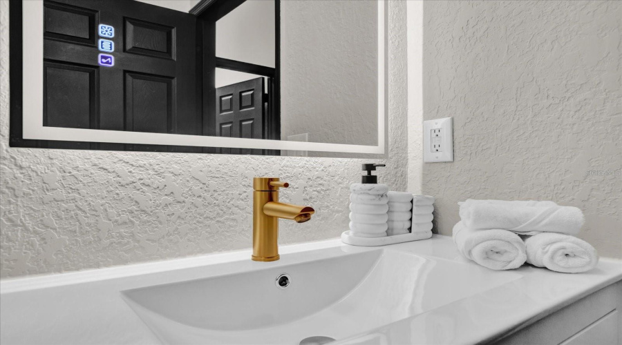 Modern vanity and fog free mirror in guest bathroom