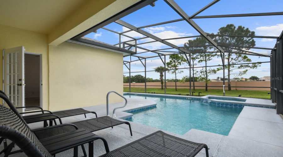 Wonderful entertainment area by the pool featuring lounge chairs and deck