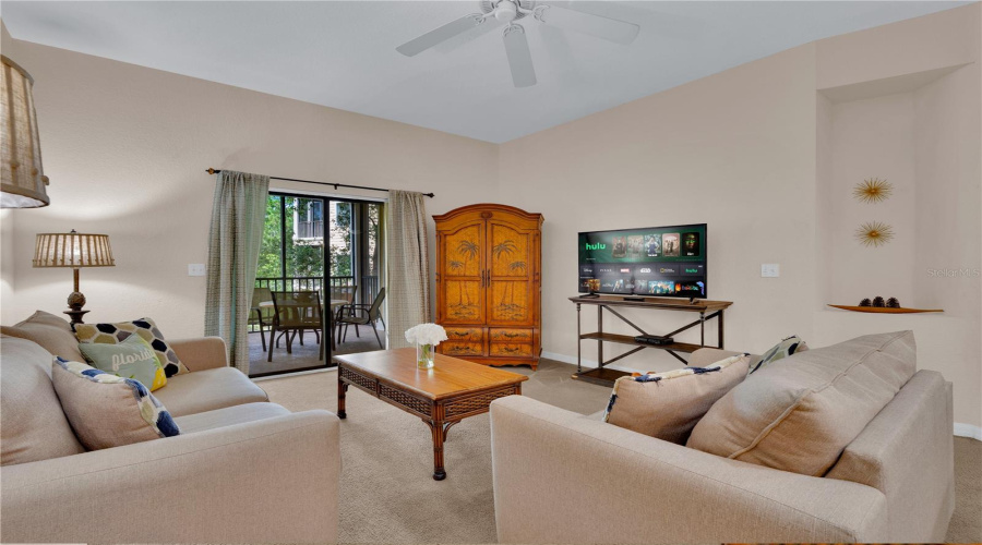 Living room. Open floorplan to kitchen and dining room. Sliding door to spacious balcony!