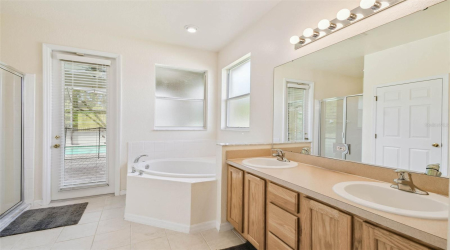 The main-floor primary suite features brand new hardwood flooring, a large ensuite bathroom with dual sinks, a garden tub, walk-in shower, and a private water closet.