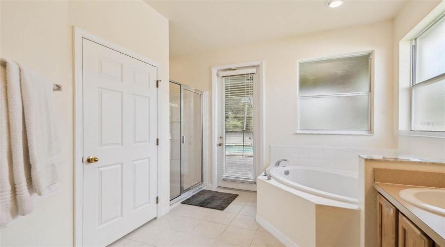 The main-floor primary suite features brand new hardwood flooring, a large ensuite bathroom with dual sinks, a garden tub, walk-in shower, and a private water closet.
