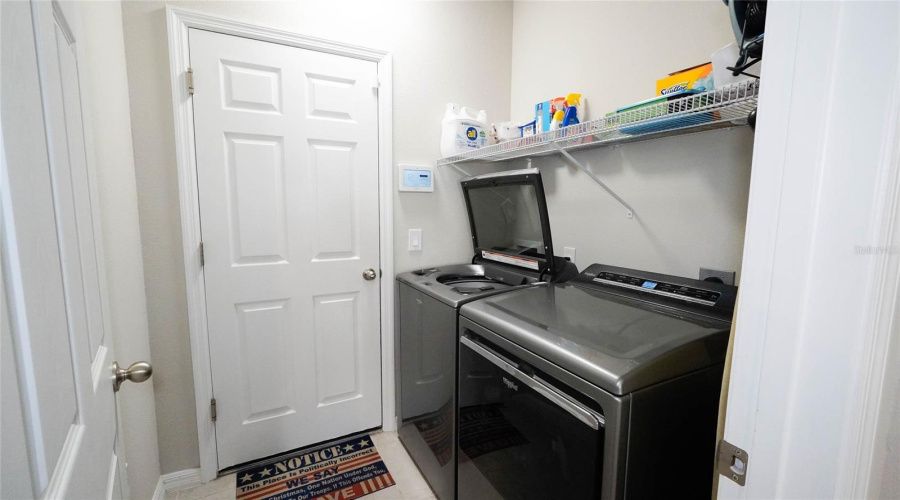 Laundry area off kitchen leads into the garage.