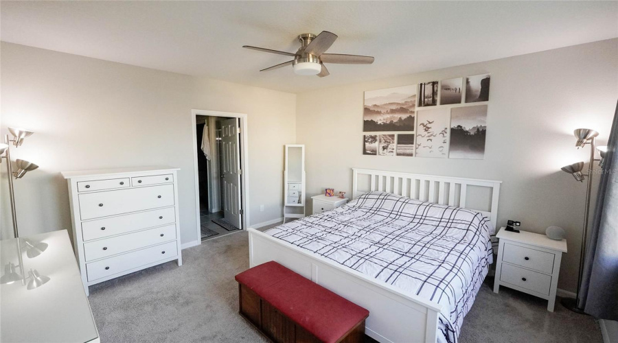 Main floor primary bedroom with ensuite bathroom and large walk-in-closet.