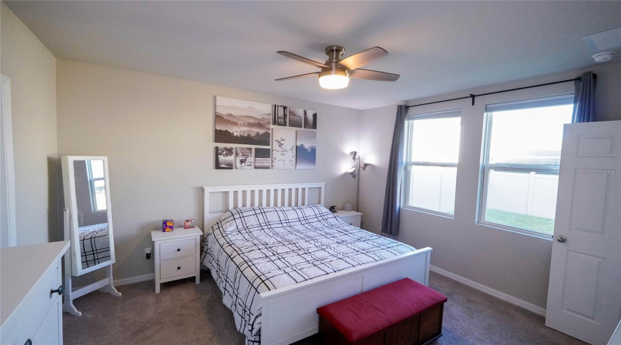 Natural light with a view of the back yard from the primary bedroom on the main floor.