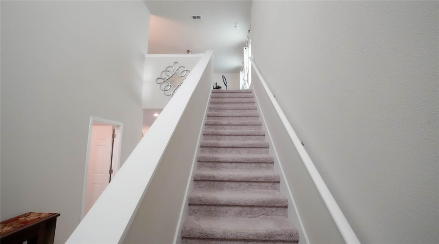 inviting open entry area with stairs to the second floor.