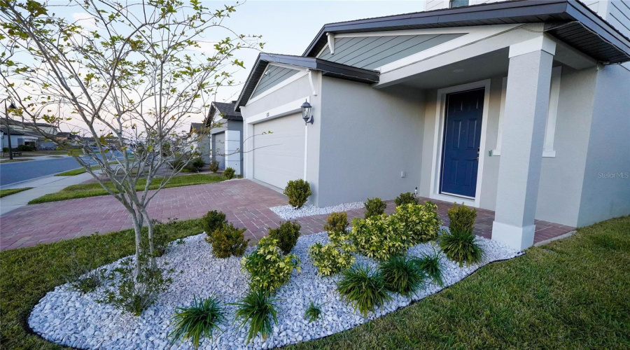 Well landscaped with a covered front porch.