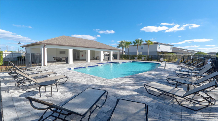 Relaxing pool area features plenty of loungers and a large covered area.