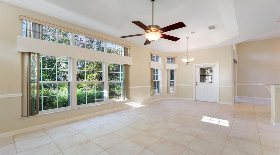 Family room has tray ceiling and door to lanai
