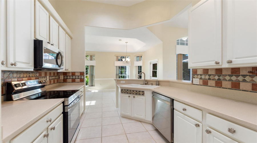 Galley kitchen with Corian countertops and 3 new stainless-steel appliances