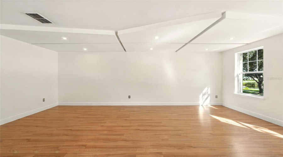 Living Room With Laminate Wood Floors and Recessed Ceiling Lights