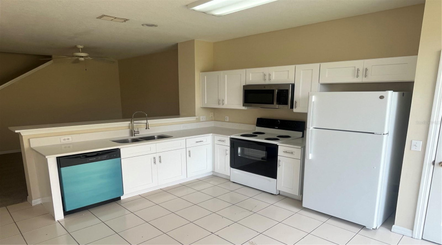 Newly Renovated Kitchen with Quartz Countertops, White Soft Closing Shaker Cabinets, New Dishwasher, Sink, Faucet, Garbage Disposal and Refrigerator.