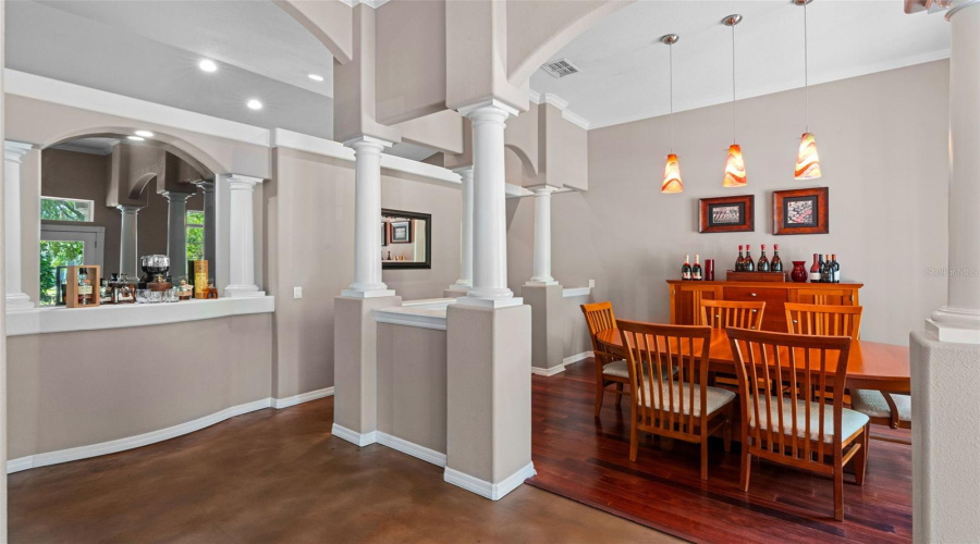 Step through the grand columned entrance and into true Southern hospitality. Just beyond the front door, you're greeted by soaring ceilings, a formal dining room ready for cherished gatherings, and a versatile formal living space that doubles perfectly as an office or parlor. Grace, charm, and welcome-home warmth await.