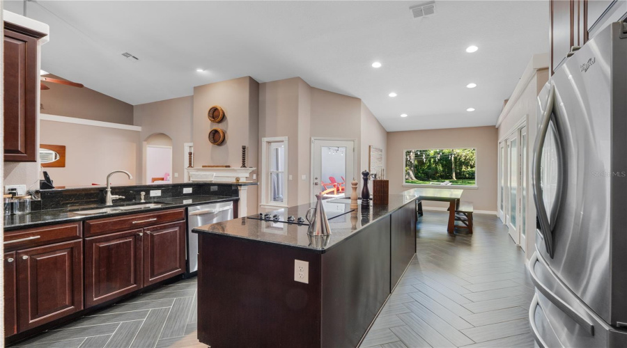 A Culinary Dream KitchenStunning granite countertops, a spacious center island, stainless steel appliances, and a sleek cooktop come together to inspire your inner chef. With ample cabinetry, generous pantry storage, and effortless flow for entertaining, this kitchen is as functional as it is beautiful.