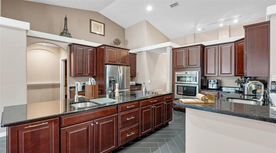 Entertain with ease and savor every moment in a kitchen crafted for cooking, designed for gathering—complete with herringbone floors and head-turning charm.