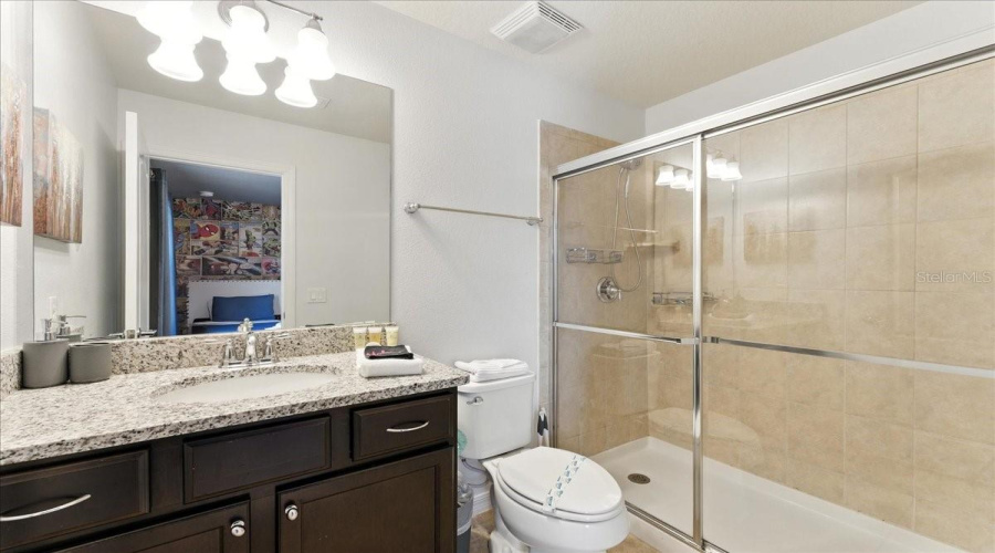 Bathroom 3 - granite counter vanity and large shower.