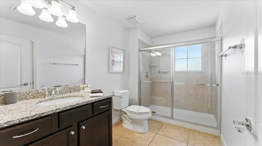 Jack-and-Jill bath off the Minnie room, giving guests their own space without losing convenience.