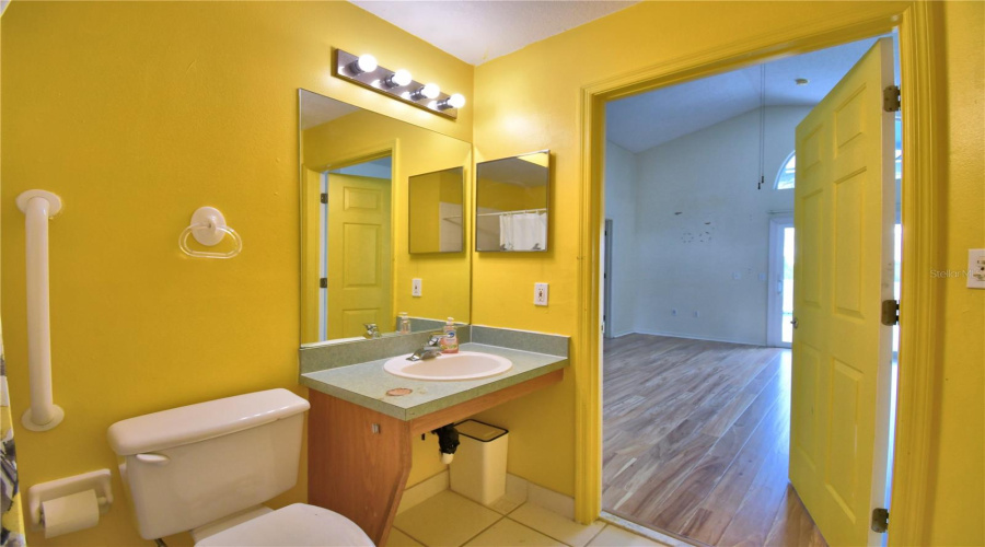 High toilet and low vanity to roll under.