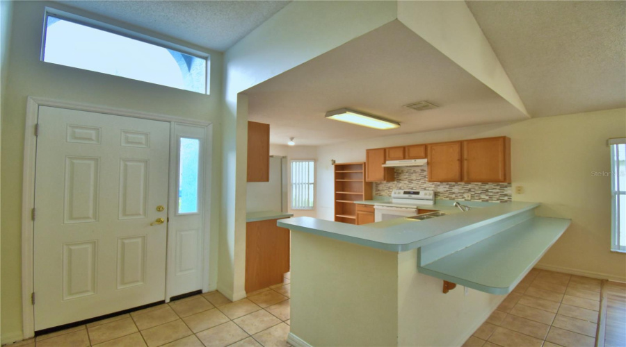 Front entry is by the kitchen.
