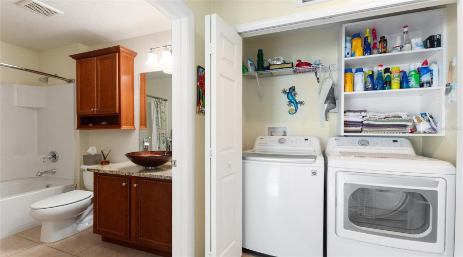 Laundry area between guest bath and bedroom