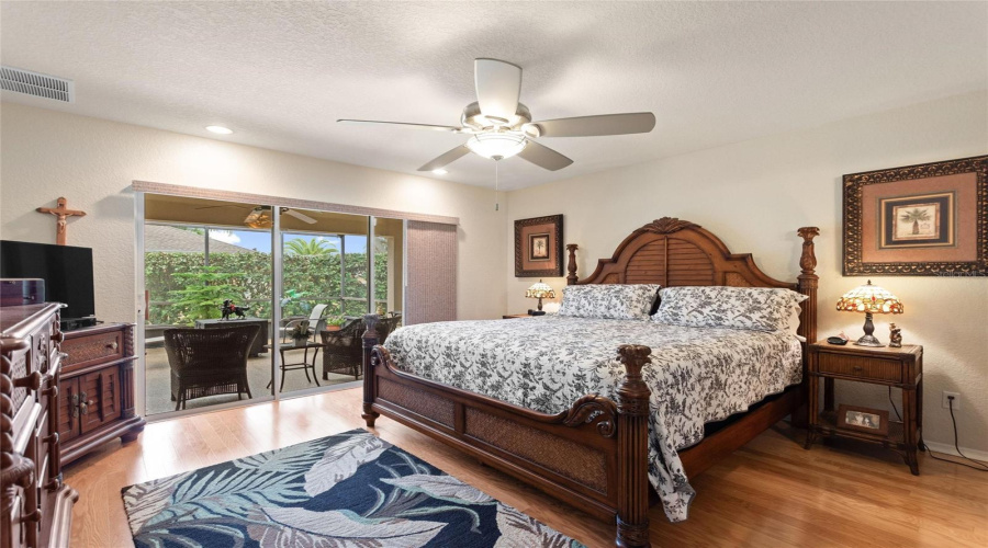 Primary en suite bedroom has patio doors to lanai