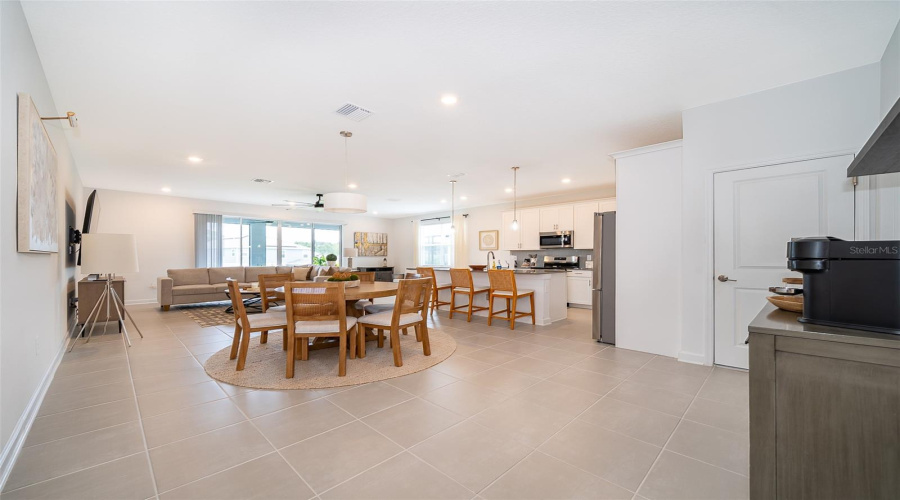 View of open area looking at Dining area, main kitchen and living room.