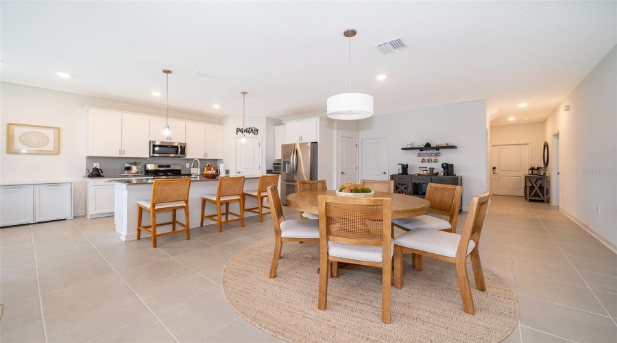 Main dining room and kitchen looking to the front entrance.