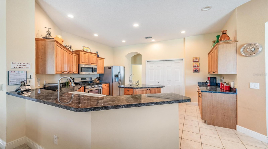 Generous countertop areas offer both functionality and space for guests to gather and sit comfortably.