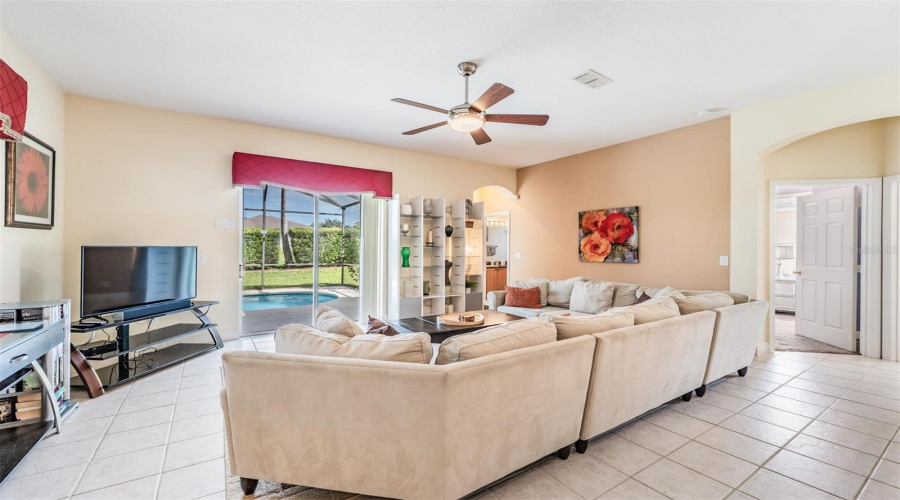 Sliding glass doors connect the great room to the pool, creating a perfect indoor-outdoor flow.