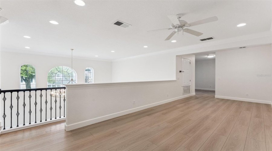 Spacious loft offers a versatile open area ideal for a playroom, home gym, office, or media space.