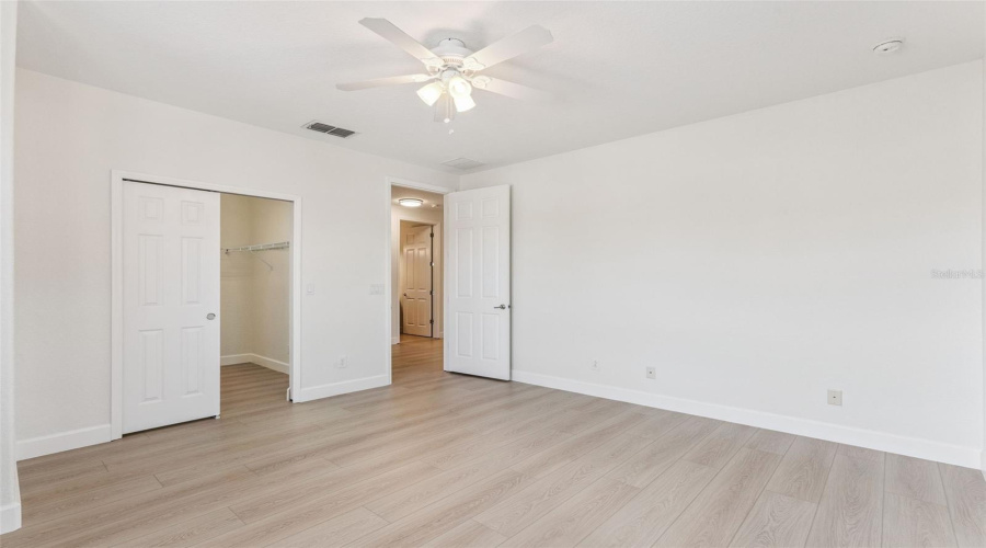 Bedroom 4 is bright and spacious with a large walk-in closet for ample storage.