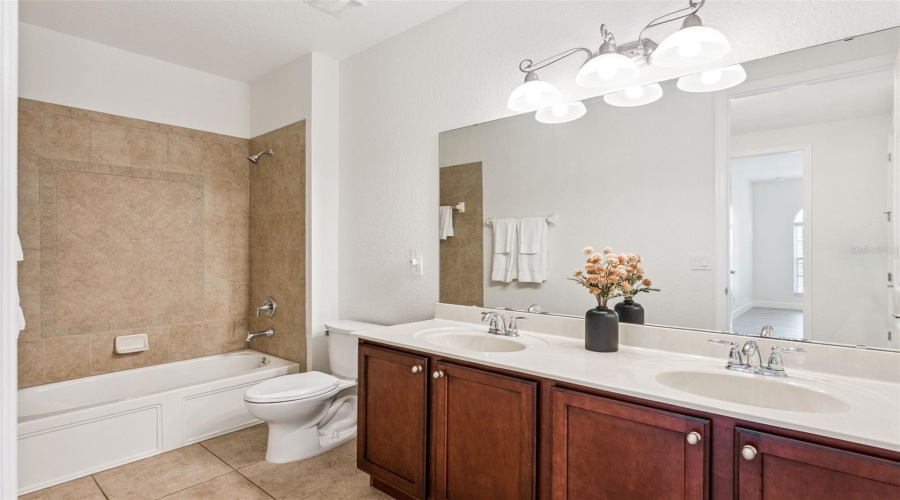 Guest bathroom with dual vanities and ample counter space.