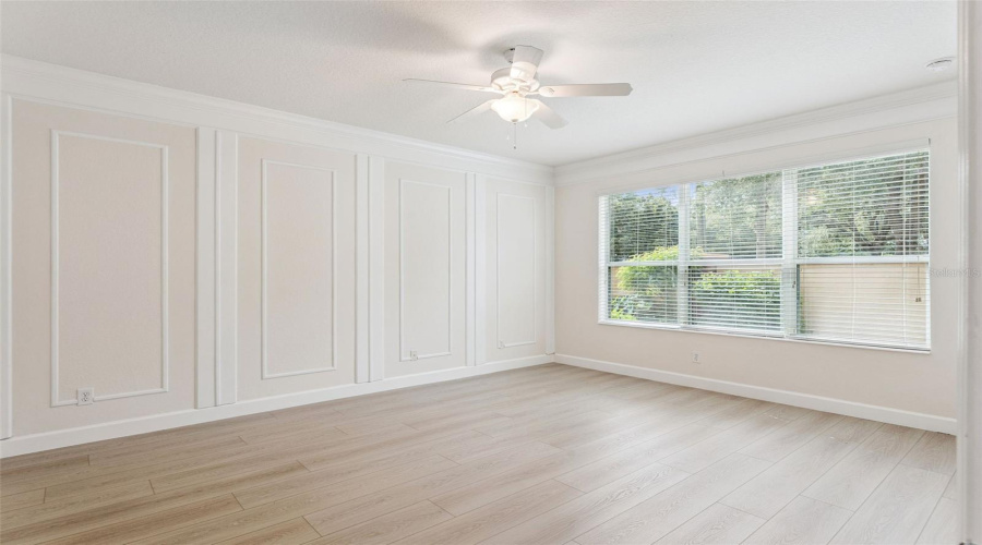 Master bedroom is located on the first floor offering beautiful crown molding, decorative accent walls, high ceilings, and large windows.