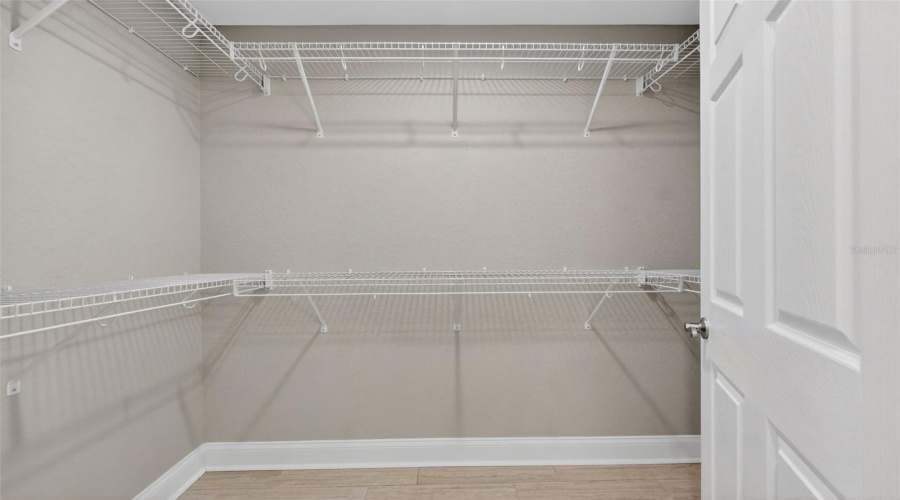 Walk-In Closet: Spacious walk-in closet with ample storage and organization potential.