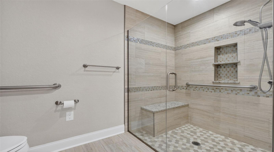 Primary Bathroom: Contemporary en-suite bath with walk-in shower and upgraded finishes.